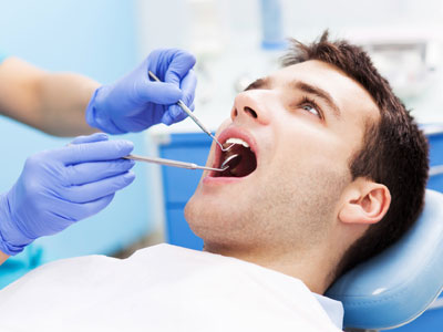 Dentist examining patient mouth