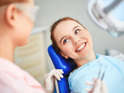 Smiling woman sitting 9on dental chair